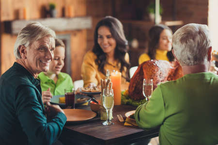 Photo of big family thanks giving event turkey served dinner communicating have fun house living...