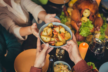 Cropped photo table arms share treat fried potato thanks giving dinner garnished turkey evening...