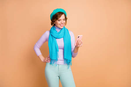 Portrait of her she nice attractive lovely pretty charming cheerful cheery girl using cell browsing...