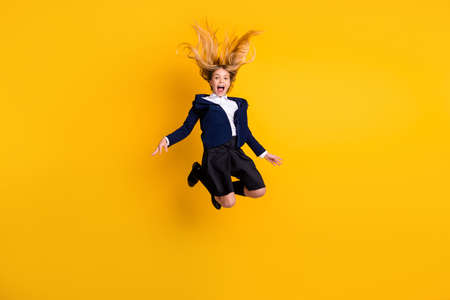 Full length body size profile side view small little cheerful schoolchild jumping having fun fooling...