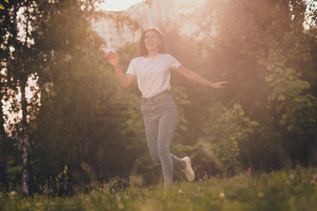 Full length body size view of her she nice attractive pretty lovely cheerful cheery girlfriend meeting boyfriend having fun running sport good mood healthy life spending free time sunlightの写真素材