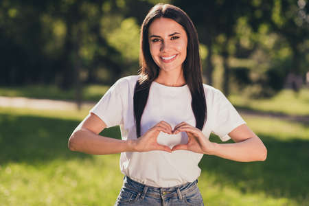Portrait of her she nice-looking attractive lovely charming lovable cheerful cheery girl enjoying rest relax botanic garden fresh air showing heart shape symbol amour affectionの写真素材