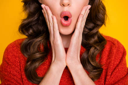 Close up cropped photo of astonished girl hear unexpected news impressed touch hands face isolated over vivid color backgroundの写真素材