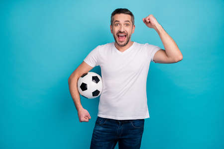 Portrait of his he nice attractive lucky cheerful cheery glad bearded guy holding in hand ball...