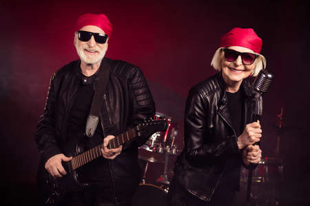 Photo of aged lady man popular old rock group family concert play solo guitar sing legendary world...