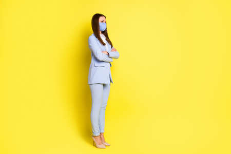 Full size profile side photo marketer agent girl cross hands copyspace hear chief work office safe respiratory mask wear blue pants blazer high-heels isolated bright shine color backgroundの写真素材