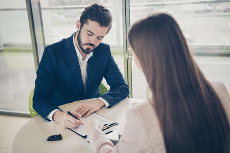 Portrait of his he her she two nice stylish focused people guy agent broker signing contract...