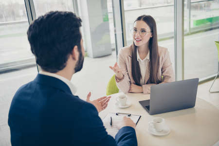Portrait of his he her she two nice attractive stylish cheerful skilled people sales marketing management meeting gathering sharing experience advice at light white workplace workstationの写真素材