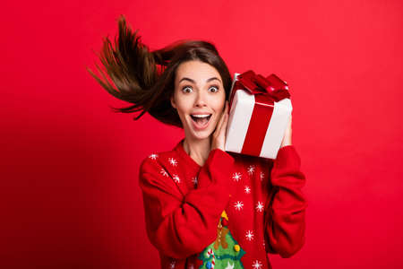 Close-up portrait of her she attractive glad cheerful amazed girl holding in hands festal gift...