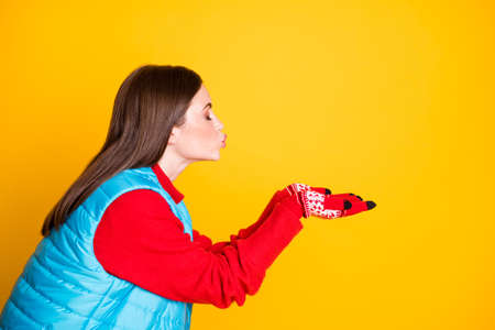 Profile side photo of lovely charming dreamy girl hold hand send air kiss her boyfriend want date wear season jumper isolated over bright shine color backgroundの写真素材