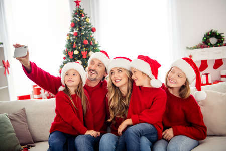 Full family x-mas vacation. People mommy mom daddy dad three preteen small kids sit sofa make selfie...