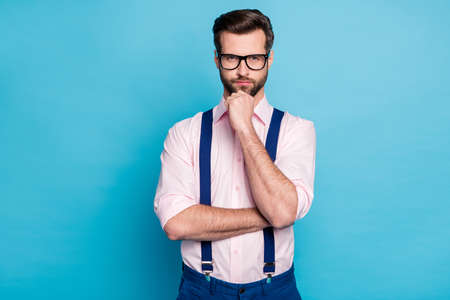 Photo of handsome business man trend outfit eyesight vision specs hold arm on chin seriously look think creative idea wear pink shirt suspenders pants isolated pastel blue color backgroundの写真素材
