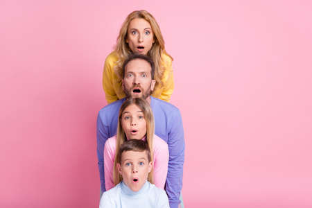 Photo of astonished stack faces mom dad little girl boy look in camera open mouth isolated on pastel color backgroundの写真素材