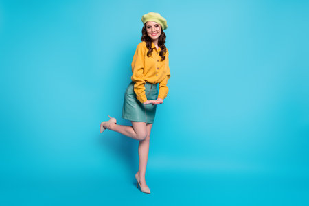 Full length photo of nice charming attractive girl enjoy rest relax wear good look, clothes isolated over blue color backgroundの写真素材