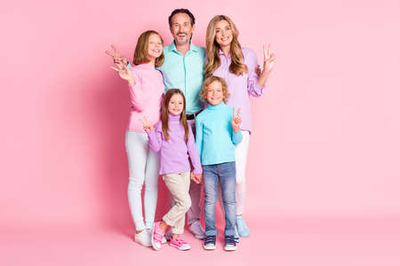 Full length photo of positive harmony dream big full family mom dad with three kids boy girls enjoy togetherness make v-sign isolated over pastel color backgroundの写真素材