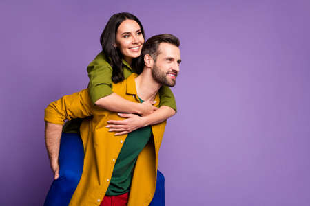 Portrait of his he her she nice attractive lovely cheerful cheery dreamy couple piggy backing having fun weekend isolated on bright vivid shine vibrant lilac violet purple color backgroundの写真素材