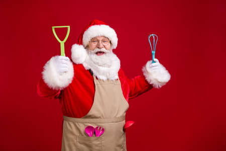 Photo of crazy modern funky santa claus chef hold x-mas cooking kitchenware wear red costume apron...