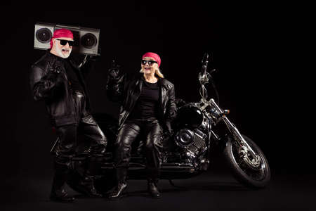 Photo of old bikers grey hair man lady couple moto chopper rock festival meeting listen tape...
