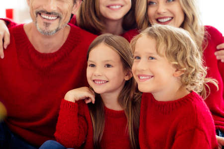 Close-up cropped view portrait of five people nice attractive cheerful cheery family embracing spending festal day vacation wearing knitwear in light white interior apartment indoorの写真素材