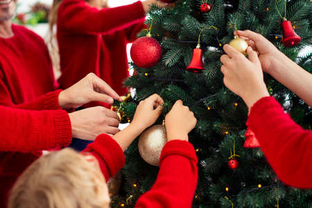 Cropped view of nice attractive big full cheerful family small little kids decorating natural...