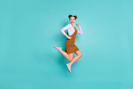 Full length profile photo of glad childish two buns hairstyle lady jump triumph arms fists wear...