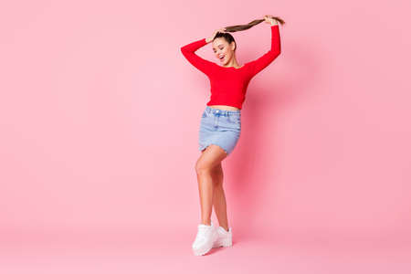 Full length body size view of her she nice-looking attractive lovely pretty gorgeous dreamy cheerful girl posing having fun spending time isolated over pink pastel color backgroundの写真素材