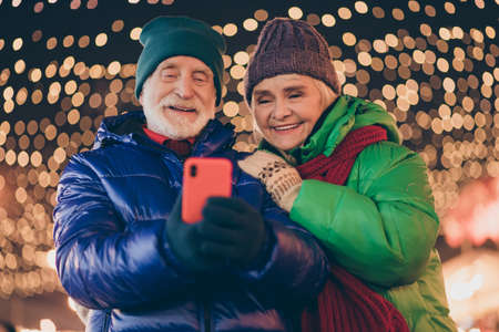 Photo of two people pensioner lovers man woman hold telephone watch funny pictures videos liking...