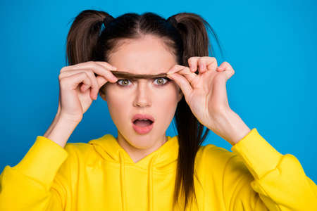 Closeup photo of pretty shocked lady hold tail making false one eyebrow open mouth need correction...