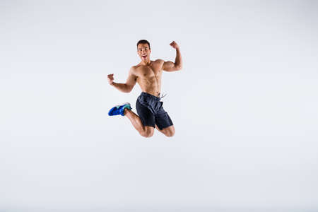 Full length body size view of his he nice attractive sportive cheerful cheery guy jumping having fun...