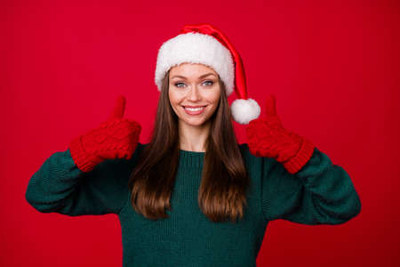 Portrait of her she nice-looking attractive pretty lovely confident cheerful girl showing double thumbup agree ad advert isolated over bright vivid shine vibrant red color backgroundの写真素材