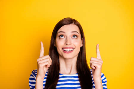 Portrait of positive girl promoter point index finger up copyspace present sales ads promo direct...