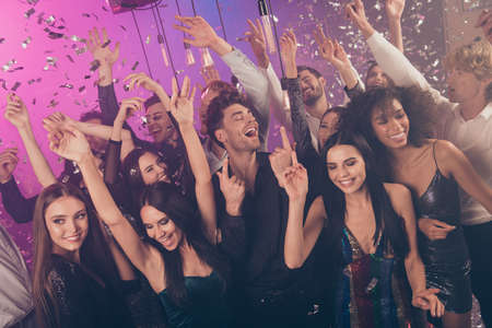 Photo of company funny positive people rise hands falling sparkles wear stylish trendy outfit modern club indoorsの写真素材