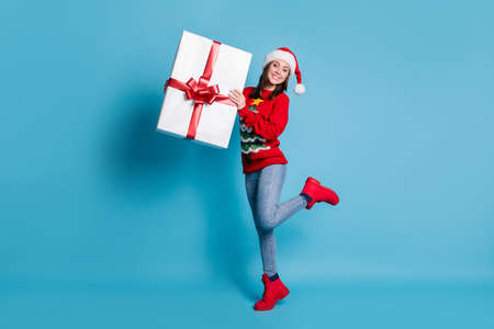 Full length body size photo of smiling millennial girl wearing festive red jumper and headwear...