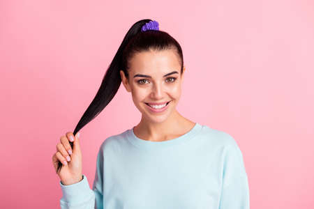 Photo of charming lady hand hold tail good mood wear sweatshirt pullover isolated pink color...