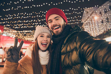 Photo of two people best friends take selfie make v-sign under outside x-mas christmas tradition...