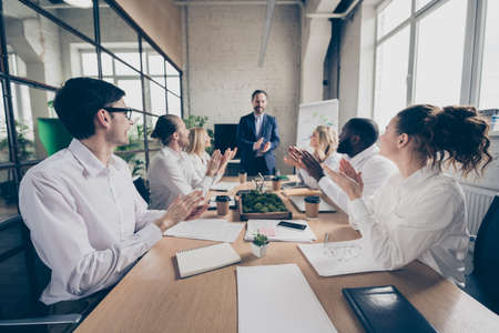 Profile side view of nice attractive stylish cheerful cheery coworkers clapping palms congratulating...