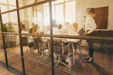 Full size photo of group of businesspeople partners have boardroom briefing sit table listen woman...