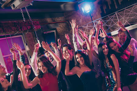 Photo portrait of millennials dancing at new year party