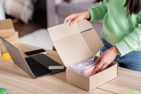 Cropped view of her she focused girl seller packing parcel trade e-commerce order sme drop-shipping industry distribution marketplace cell phone cases assortment home-based officeの写真素材