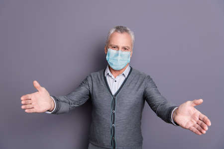 Portrait of banker economist in casual formal-wear mask welcoming you to join isolated over gray pastel backgroundの写真素材