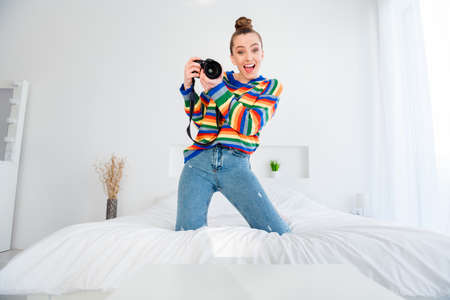 Photo of pretty attractive excited lady shooting pictures for boyfriend posing professional camera...