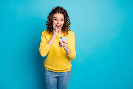 Portrait of her she nice attractive lovely amazed cheerful cheery wavy-haired girl using gadget app...