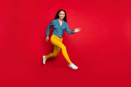 Full length body size view of attractive fit cheerful girl jumping running active motion isolated...