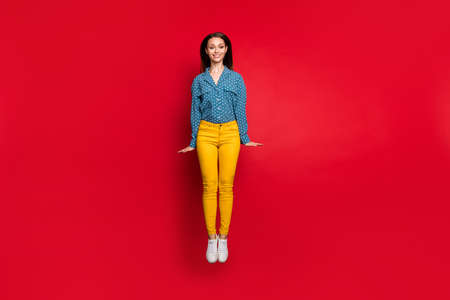 Full length body size view of pretty shy feminine thin cheerful girl jumping having fun isolated...
