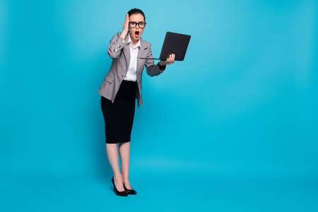 Full length body size view of nice stunned lady IT specialist holding in hands laptop omg news...