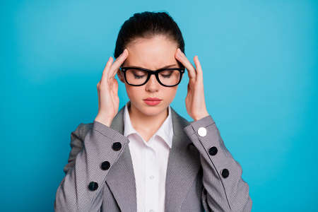 Close-up portrait of attractive sick sullen businesslady feeling bad touching temples isolated over...