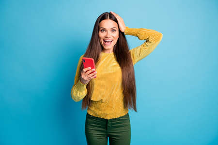 Photo portrait of girl holding red phone head with one hand isolated on pastel blue colored...