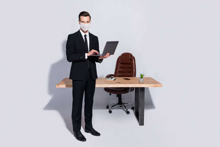 Full body photo of handsome business guy hold notebook hands wear white face mask isolated grey backgroundの写真素材