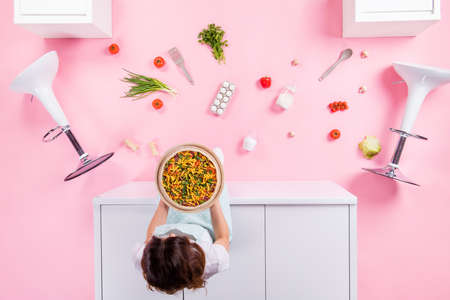 Top above high angle view full length photo of girl sit table look eggs pepper tomato kitchen utensils hold ready prepared baked pizza flat lay floor isolated over pastel color backgroundの写真素材