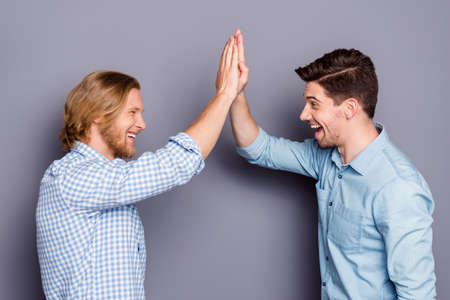 Profile side view portrait of two nice attractive glad cheerful cheery guys best buddy fellow...